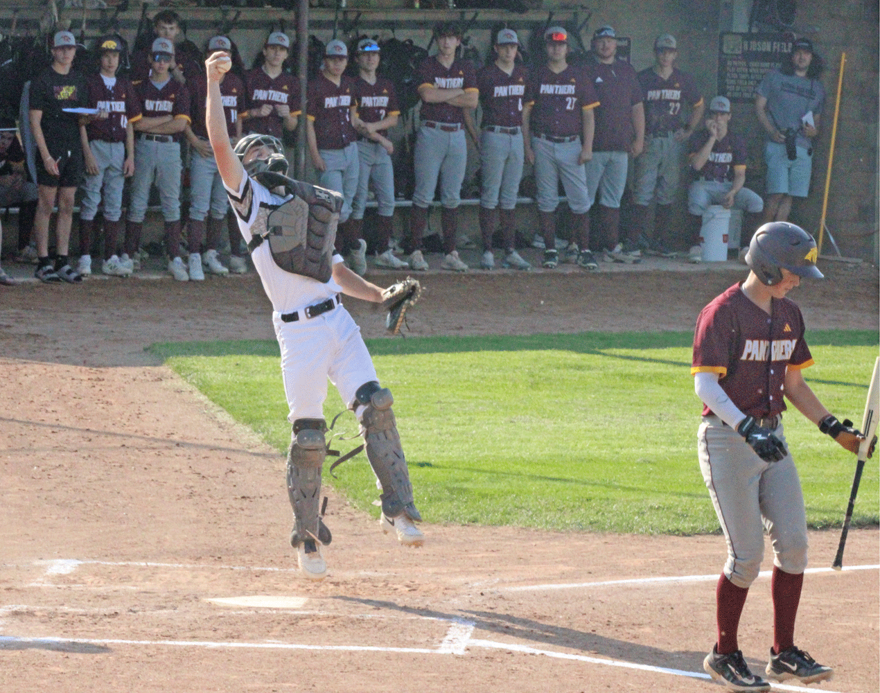 Caledonia catcher Jacob Klug fields the ball with his throwing hand on a bunt attempt by Pine Island’s Alex Knox (also shown), who unwittingly does not know the ball in in fair territory, in the team’s section 1AA final contest. Klug got the out at first. Photo by Paul Trende