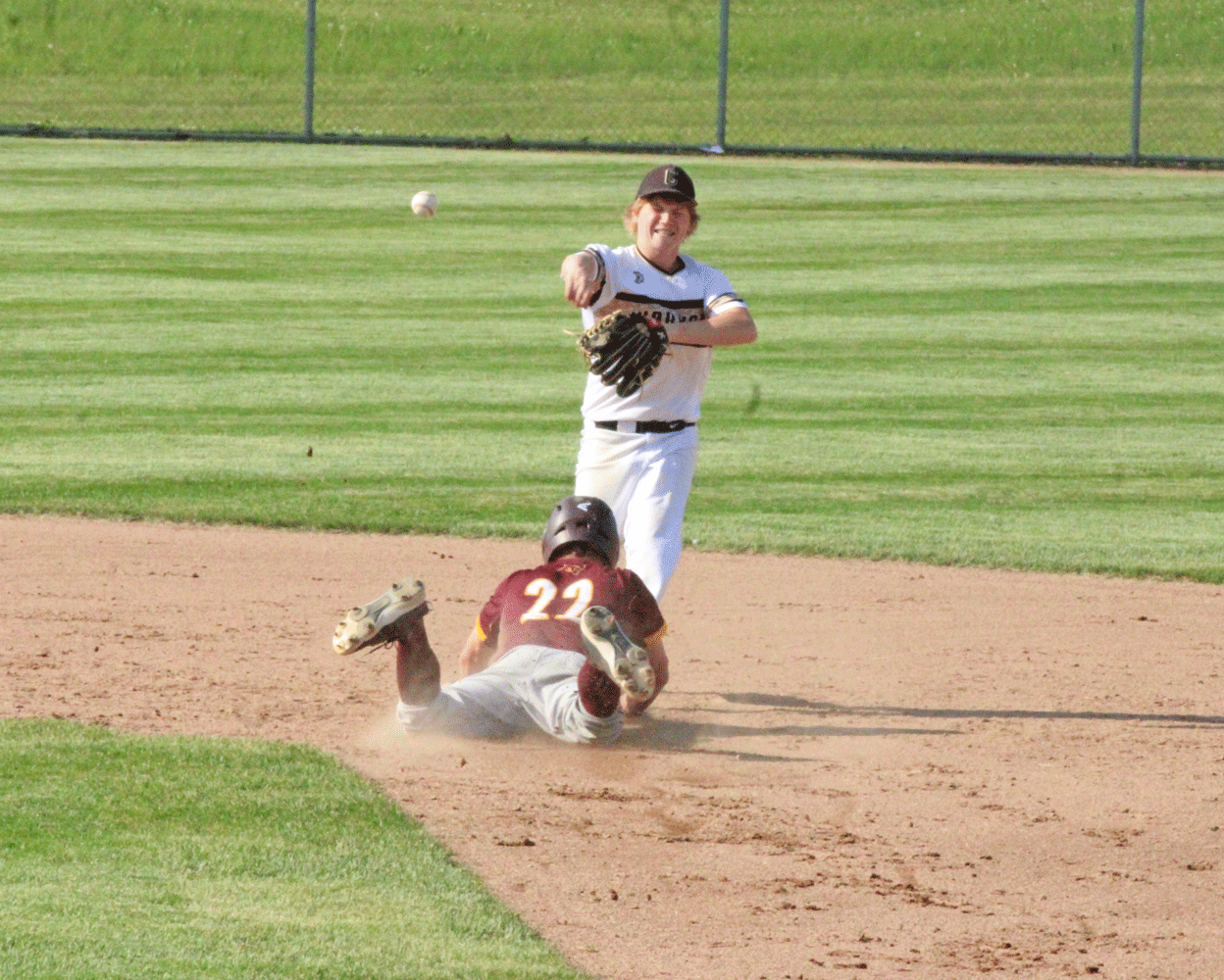 Caledonia second baseman Tanner Ginther looks to turn the double play in the Warriors 1AA final versus Pine Island. Photo by Paul Trende