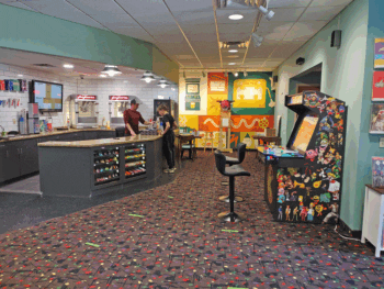 Owner Lucas Hall assisting a guest at the concession counter in the lobby of the theater.