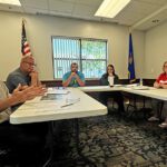 Public Works Director Bob Mierau explains the safety issues at the alley intersection with Prairie Avenue to the audience, as Councilor Kelly Sand, Mayor Adam Wilder, City Clerk Karen Larson, and Councilors Valerie Arnold and Tina Bakke listen intently. Photo by Charlene Corson Selbee