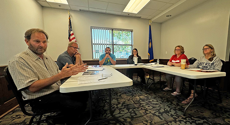 Public Works Director Bob Mierau explains the safety issues at the alley intersection with Prairie Avenue to the audience, as Councilor Kelly Sand, Mayor Adam Wilder, City Clerk Karen Larson, and Councilors Valerie Arnold and Tina Bakke listen intently. Photo by Charlene Corson Selbee