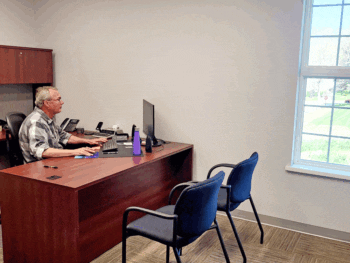 Dean Aug working in his new office.