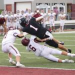 Chatfield safety Kaisen Johnson (#6) takes a lick but brings down Triton QB Pierce Petersohn just short of the goal line to deny a would-be game-winning second-overtime two-point conversion and enable the Gophers to post a huge 24-23 sub-district win. They improved to 4-0. Photo by Paul Trende