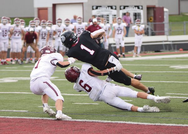 Chatfield safety Kaisen Johnson (#6) takes a lick but brings down Triton QB Pierce Petersohn just short of the goal line to deny a would-be game-winning second-overtime two-point conversion and enable the Gophers to post a huge 24-23 sub-district win. They improved to 4-0. Photo by Paul Trende