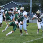 A pivotal play in the game, Caledonia’s Cooper Allen (#52) and Jack Schmitz (#23) tackle Rushford-Peterson’s Will LaFleur near the goal line following an interception. LaFleur fumbled, but R-P’s Jaxson Meldahl recovered for a touchdown, part of the Trojans’ notable 21-14 season-opening win. Photo by Paul Trende