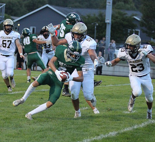 A pivotal play in the game, Caledonia’s Cooper Allen (#52) and Jack Schmitz (#23) tackle Rushford-Peterson’s Will LaFleur near the goal line following an interception. LaFleur fumbled, but R-P’s Jaxson Meldahl recovered for a touchdown, part of the Trojans’ notable 21-14 season-opening win. Photo by Paul Trende