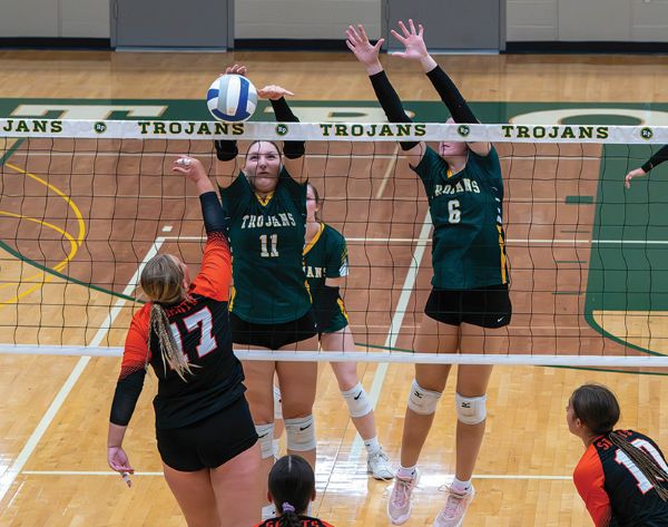 Rushford-Peterson’s Madison Ingvalson and Ava Helgemoe form a double-block on the attack of St. Charles’ Kierstyn Sanders in the Trojans’ 3-0 homecoming sweep. R-P (4-1, 7-2) sits behind Caledonia (6-0, 15-3) and Fillmore Central (5-0, 13-4) in the TRC standings. Photo by Dawn Hauge
