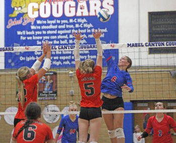 Mabel-Canton’s Tylar Wenthold attacks against the double-block of Lanesboro defenders Sari Rein (left) and Emma Ruen (right). M-C, ranked #4 in Class A, controlled the match by sweep (25-17, 25-17, 25-13) to improve to 7-0 on the year. Photo by Paul Trende