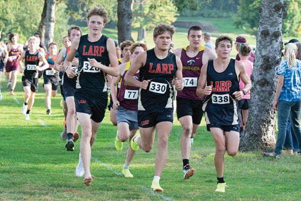 LARPH runners Isaac Rasmussen, Trey Hegland and Grayson Speltz lead the pack at a home four-team cross country meet. The #3-ranked Card-Tro-Cane boys won said team competition with the above trio claiming the top three spots. Photo by Dawn Hauge: