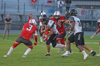 Kingsland’s Bently Wiersma looks to lower the boom for additional yardage versus Faribault B.A. defender Hayden Dillon in the Knights’ season-opening 48-0 road win. Photo by Christine Vreeman
