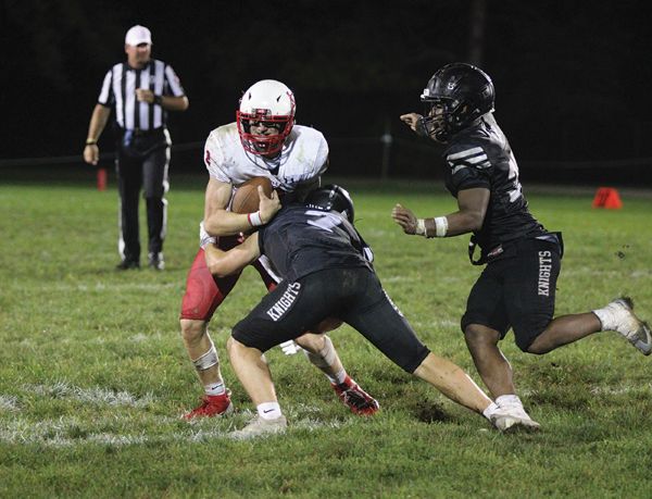 Kingsland’s Michael Johnson makes the tackle on LeRoy-Ostrander/Lyle/Pacelli’s Reid Hungerholt while KD Reiland is also lurking. Johnson had the game-sealing interception of Hungerholt in the end zone as time expired to cement a wild 40-32 Knight win. They improved to 4-0. Photo by Paul Trende