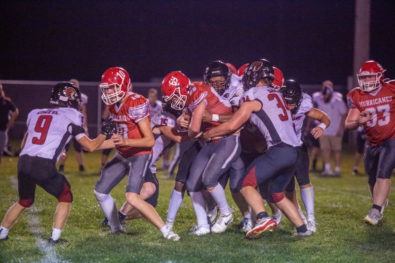 Houston’s Elliot Frauenkron battles forward against the Spring Grove defenders including Christian Bjerke (#34), Caden Gerard (#15), and others. Houston ended a 20-game losing streak to the Lions via a 24-18 victory. Photo by Emma Geiwitz