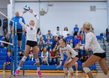 Chatfield attackers Cora Bicknese (far) and Grace Schroeder (near) eye Harper Goldsmith’s set in Chatfield’s matchup with Cotter/Hope Lutheran. A rematch of last year’s 1AA title game, the Gophers again were victorious by 3-0 sweep. Photo by Leif Erickson