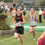 LARPH Isaac Rasmussen (left) is within a few hundred yards of the finish at the Luther All-American cross country meet. Featuring many ranked runners and teams from the Tri-State area, Rasmussen took an impressive 11th place (of over 200 competitors) to help his team to a strong fifth place showing. Photo by Paul Trende