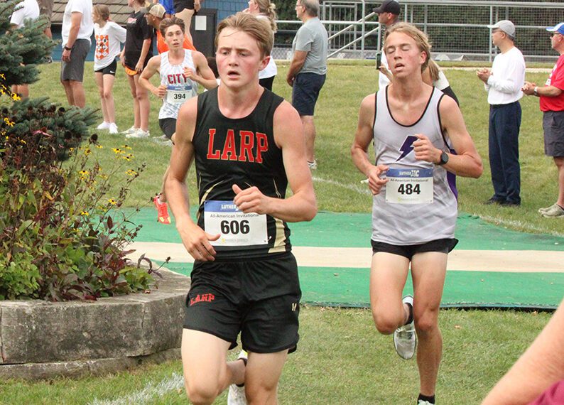 LARPH Isaac Rasmussen (left) is within a few hundred yards of the finish at the Luther All-American cross country meet. Featuring many ranked runners and teams from the Tri-State area, Rasmussen took an impressive 11th place (of over 200 competitors) to help his team to a strong fifth place showing. Photo by Paul Trende