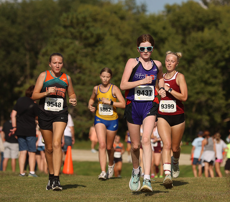 Area girls cross country runners (left to right) Isabelle Peterson of L/FC, Audrey Main of GM/L-O/S, and Kylie Sinn of Chatfield, compete at the Stewartville meet. Peterson was not one of her team’s scoring runners, but the Burro girls took second at the event. Photo by Christine Vreeman