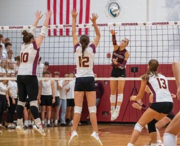 Chatfield senior Trindy Barkeim attacks from off the next over Dover-Eyota defenders Shelby Clark (#10) and Faith Kurtz (#12) in the Gophers’ 3-0 league win. Chatfield (4-2, 12-6), ranked #4, also took on the Class AA Showcase, going 3-2, taking third place overall. Barkeim made the All-Tourney team. Photo by Leif Erickson