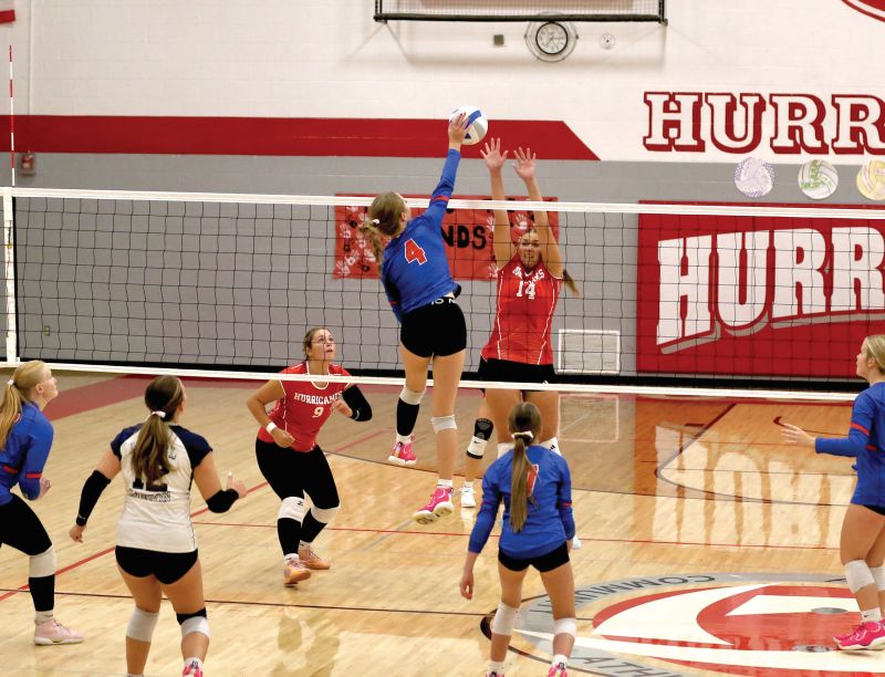 Mabel-Canton’s Ella Halverson goes high for an attack over Houston’s Jorja Meyer in the Cougars’ 3-0 sweep. SEC-East leading M-C improved to 3-0 in league and 8-0 overall with the win. Photo by Craig Johnson