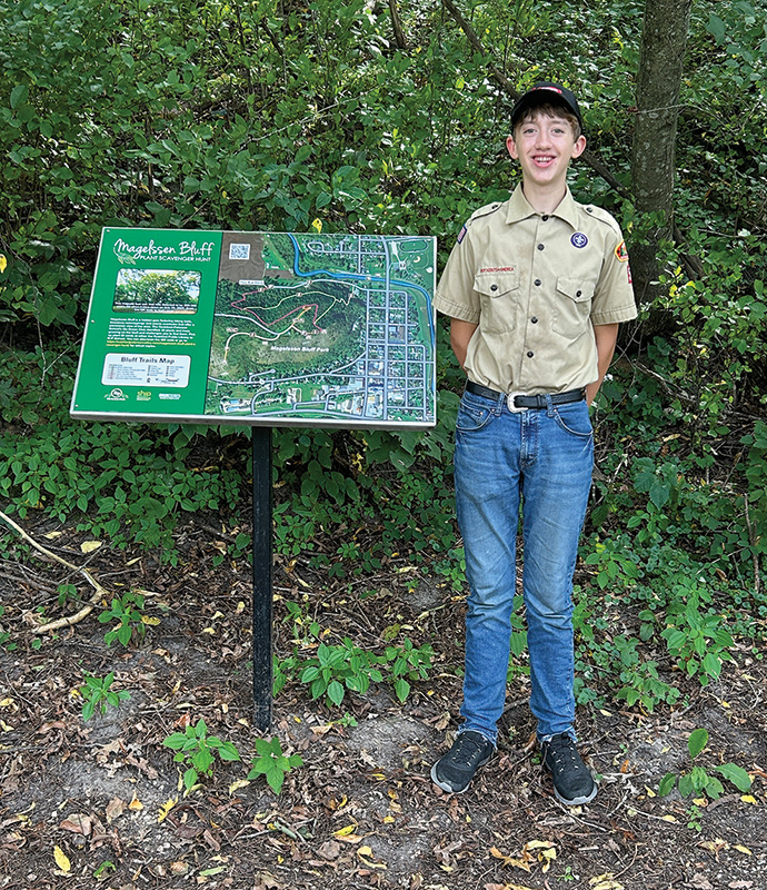 Mannix Darr worked with Mr. Kramer and Sally Ryman to design the kiosk sign; Mannix worked to install the trail signs and kiosk sign as his Eagle Scout project. Photo by Wanda Hanson