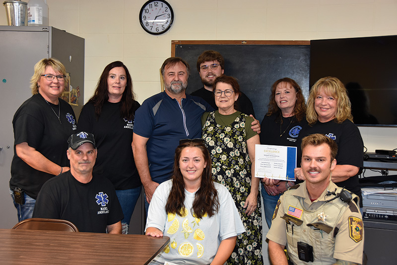 WinnMed Director of Ambulance, Steve Vanden Brink, recognized EMS personnel for their life-saving response after Kala Exworthy suffered a sudden cardiac arrest. Her fiance Rory Welper, along with family, were present to witness the recognition. Front row, left to right: Jason Marquardt, Dispatcher Courtney Nelson, and Fillmore County Deputy Jordan Rudolph. Second row: Shelly Gerard, Mabel Ambulance Director Sarah Mengis, Rory Welper, Kala Exworthy, Jeanette Paul, and Sheri Marquardt. In back is Travis Vatland. Photo by Charlene Corson Selbee