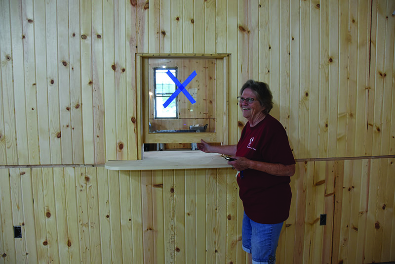Preston Historical Society President Sheila Craig gave an impromptu tour of the Preston Depot Museum and Riverfront Center. She points out one of the future hands-on interpretive exhibits, a ticket booth. Photo by Charlene Corson Selbee