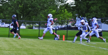 Fillmore Central’s Cody Serfling leaves a trio of Rebel defenders in his wake in scoring a first quarter touchdown in the teams’ week two affair. FC overcame a 14-6 halftime deficit to lead 30-14 late, ultimately winning 30-22 to improve to 2-0. Photo by Deb Finseth