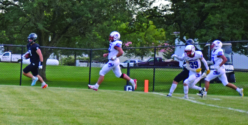 Fillmore Central’s Cody Serfling leaves a trio of Rebel defenders in his wake in scoring a first quarter touchdown in the teams’ week two affair. FC overcame a 14-6 halftime deficit to lead 30-14 late, ultimately winning 30-22 to improve to 2-0. Photo by Deb Finseth