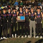 The Section 1A champion #1 in state in Class A Lewiston-Altura/Rushford-Peterson/Houston boys cross-country team and its coaches. The Card-Tro-Canes won their third straight title (fourth in five years) with their lowest team score in their seven-year state era. Photo by Christine Vreeman