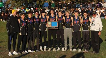The Section 1A champion #1 in state in Class A Lewiston-Altura/Rushford-Peterson/Houston boys cross-country team and its coaches. The Card-Tro-Canes won their third straight title (fourth in five years) with their lowest team score in their seven-year state era. Photo by Christine Vreeman