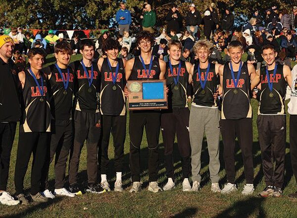 The Section 1A champion #1 in state in Class A Lewiston-Altura/Rushford-Peterson/Houston boys cross-country team and its coaches. The Card-Tro-Canes won their third straight title (fourth in five years) with their lowest team score in their seven-year state era. Photo by Christine Vreeman