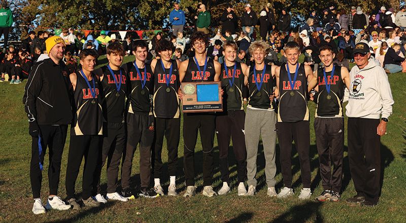 The Section 1A champion #1 in state in Class A Lewiston-Altura/Rushford-Peterson/Houston boys cross-country team and its coaches. The Card-Tro-Canes won their third straight title (fourth in five years) with their lowest team score in their seven-year state era. Photo by Christine Vreeman