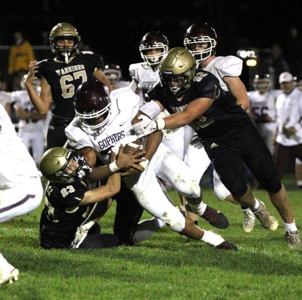 In a renewal of a bitter Class AA rivalry, Caledonia got redemption on a loss in last year’s 1AA title game by knocking #2 Chatfield from the ranks of the undefeated. Jack Schmitz (#23) and Cooper Allen (#52) curtail Gopher running back D’Andre Williams as a part of the Warriors’ 14-0 win. Photo by Paul Trende