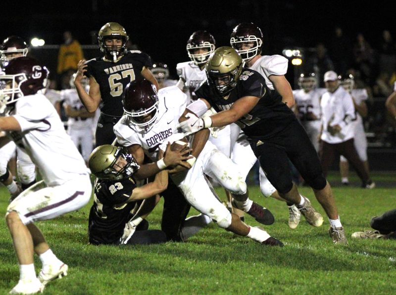 In a renewal of a bitter Class AA rivalry, Caledonia got redemption on a loss in last year’s 1AA title game by knocking #2 Chatfield from the ranks of the undefeated. Jack Schmitz (#23) and Cooper Allen (#52) curtail Gopher running back D’Andre Williams as a part of the Warriors’ 14-0 win. Photo by Paul Trende