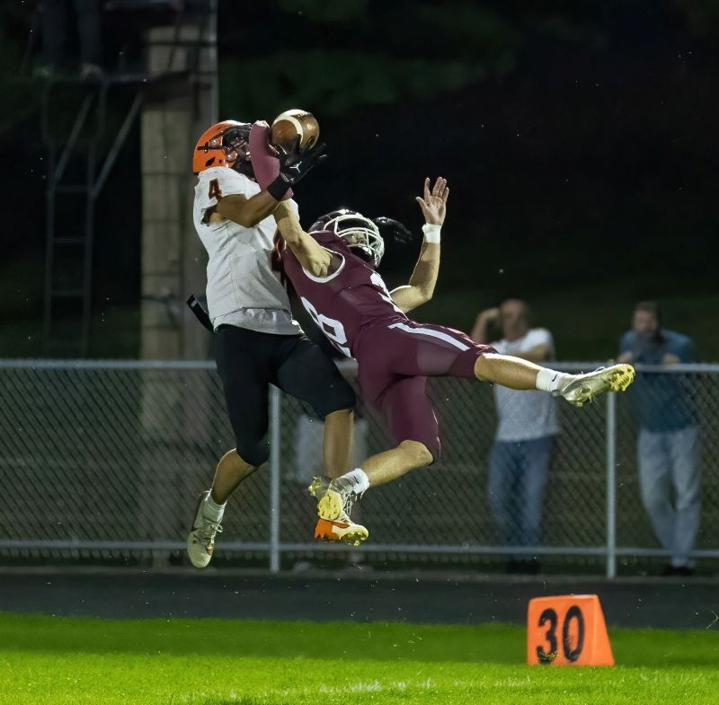 Chatfield’s Sam Carrier gets the pass deflection on a ball intended for St. Charles’ Saevian Hong in the #2 in AA Gophers 51-8 win over the Saints. Chatfield remained perfect at 6-0. Photo by Leif Erickson