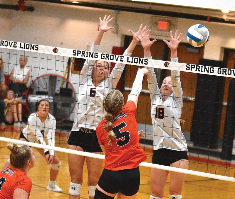 Spring Grove defenders Kylie Hammel and Jada Strinmoen cannot block down the shot of Lanesboro’s Emma Ruen in the teams’ SEC rematch. After Lanesboro took the first meeting in five sets, SG took the above contest in four, part of a 5-1 Lion week on the courts. Photo by Lee Epps