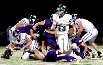 Rushford-Peterson’s Creighton Hoiness looks for running room against Rochester-Lourdes. R-P trailed 28-8 late in the third quarter, but had the ball down 28-20 late in the fourth only to come up short on 4th down. Photo by Craig Johnson