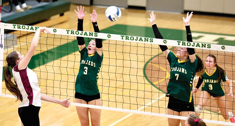 A Dover-Eyota attack gets through the block of Rushford-Peterson’s Kayla Magin and Shelby Tesch. The 8th-seed Trojans fell to the #9-seed Eagles 3-1, as R-P’s good season ended at 17-6. Photo by Craig Johnson