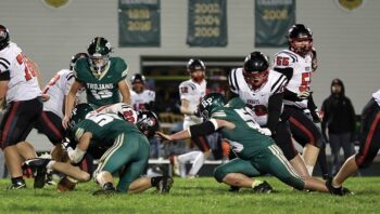 Rushford-Peterson’s Lucas Redalen (#55) makes the tackle on Kenyon-Wanamingo’s Nathan Keller while teammate Gabe Cummer (right) also closes in on the play. The Trojans ended a three-game losing streak while scoring a season-high in a 54-12 win over the Knights. Photo by Craig Johnson