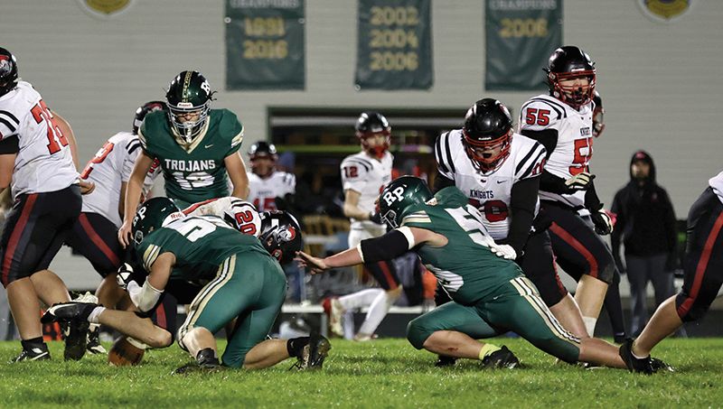 Rushford-Peterson’s Lucas Redalen (#55) makes the tackle on Kenyon-Wanamingo’s Nathan Keller while teammate Gabe Cummer (right) also closes in on the play. The Trojans ended a three-game losing streak while scoring a season-high in a 54-12 win over the Knights. Photo by Craig Johnson