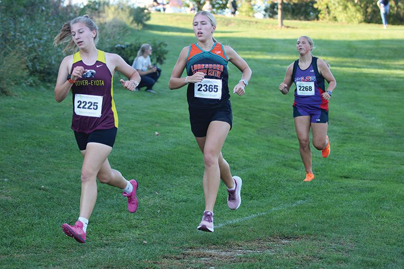 Lanesboro/Fillmore Central’s Lillyan Kiehne and GMLOS’ Naomi Warmka trail Dover-Eyota’s Hannah Halbakken early at the St. Charles cross country meet. Kiehne finished 15th and Warmka 17th to crack the top 20 at said meet. Photo by Paul Trende