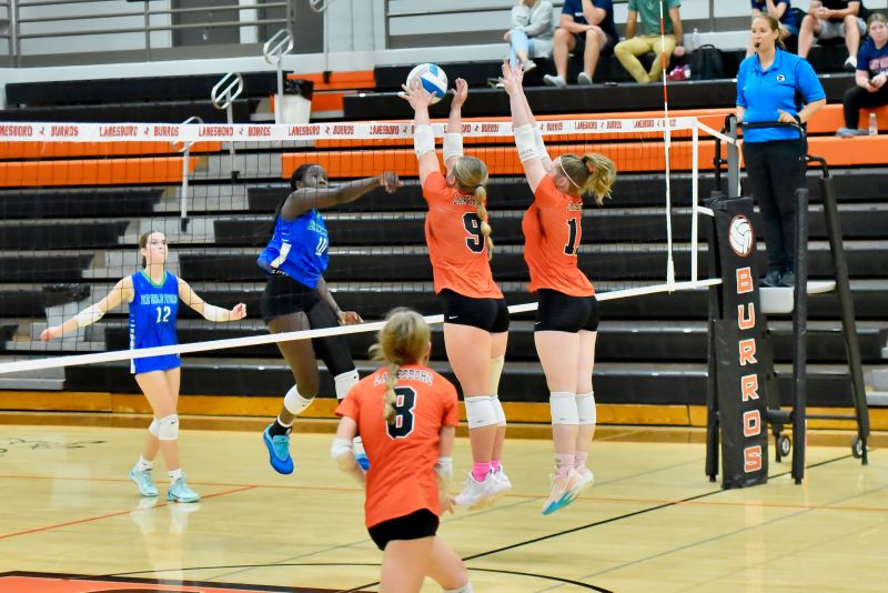 Lanesboro’s Jensyn Storhoff (#9) and Cora Mayer (#11) put up the double-block on Lyle/Pacelli’s Akeera Oman in the teams’ SEC match. The Burros came back from down 0-2 to win in five sets (20-25, 11-25, 25-18, 25-16, 15-13). Photo by Ron Mayer