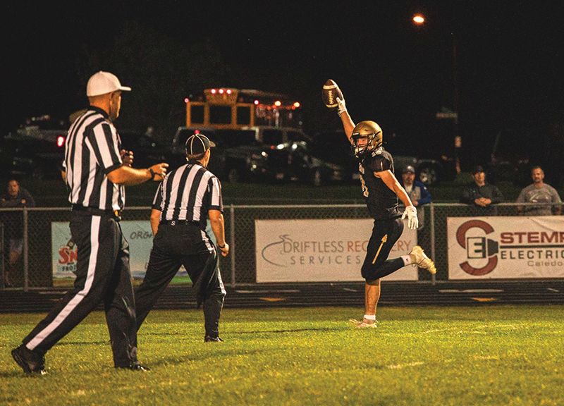 Caledonia’s Will Allen celebrates his 27-yard fourth quarter interception return touchdown to cap the Warriors 32-15 win over Rochester-Lourdes. Caledonia moved to 3-2 in the sub-district and overall with the win. Photo by Isaac Blocker