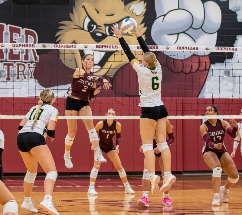Chatfield’s Cora Bicknese goes high to attack against Rushford-Peterson’s Ava Helgemoe. Chatfield (7-2, 19-7) swept the Trojans (6-2, 11-3) in a match of top four TRC teams while also taking third of 32 at the large-school Burnsville Tourney. Photo by Leif Erickson