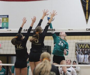 Indicative of the game, Caledonia has defenders (Ashlyn Reinhart and Kensey King) ready to block Fillmore Central’s top offensive asset Madi Zwart. The Warriors (7-0, 16-3) downed FC 3-0 (25-15, 25-14, 25-21) to take sole possession of first place in the TRC ahead of the Falcons (5-1, 14-5) and R-P (5-1, 9-2). Photo by Paul Trende
