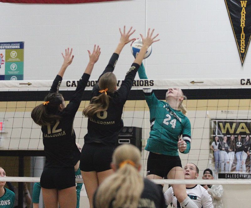 Indicative of the game, Caledonia has defenders (Ashlyn Reinhart and Kensey King) ready to block Fillmore Central’s top offensive asset Madi Zwart. The Warriors (7-0, 16-3) downed FC 3-0 (25-15, 25-14, 25-21) to take sole possession of first place in the TRC ahead of the Falcons (5-1, 14-5) and R-P (5-1, 9-2). Photo by Paul Trende