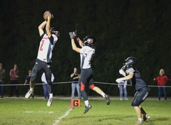 Spring Grove’s Dylan Halverson ends a Kingsland threat by making an interception at the goal-line for a pass intended for Kingsland’s Michael Johnson. Lion Ezra Konkel is also shown. For a second straight week, the Lions (4-1, 4-1) scored late to earn victory, this time handing #2 in 9-Man Kingsland (4-1, 4-1) its first loss via a 14-8 win. Photo by Christine Vreeman