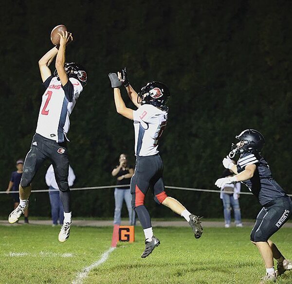 Spring Grove’s Dylan Halverson ends a Kingsland threat by making an interception at the goal-line for a pass intended for Kingsland’s Michael Johnson. Lion Ezra Konkel is also shown. For a second straight week, the Lions (4-1, 4-1) scored late to earn victory, this time handing #2 in 9-Man Kingsland (4-1, 4-1) its first loss via a 14-8 win. Photo by Christine Vreeman