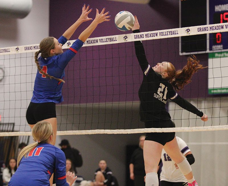 Grand Meadow’s Gracie Foster flicks the ball just past Mabel-Canton’s Ella Halverson in the teams’ SEC finale. Both teams entered the match undefeated in league play, but the Cougars (28-3) won both the above meeting 3-0, and the SEC East-West Showcase game, between the teams a night later. Photo by Paul Trende