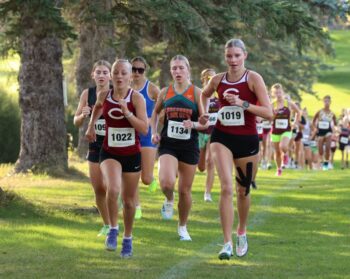 Five gals run in a pack early in the PEM Jodi Rahman cross country meet including prominently Chatfield’s Adeline Schild (left) and Lexi Kivimagi (right) plus LFC’s Lillyan Kiehne (middle) and LARPH’s Caitlin Bauer (mostly occluded left). All four finished top 10 at the event. Photo by Christine Vreeman