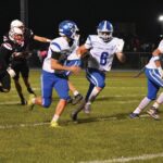 Mabel-Canton’s Breyvn Tollefsrud is in the open with a bit of a convoy from blockers Isaac Underbakke (left) and Darian Hershberger (right). The Cougars topped Wabasha-Kellogg 37-14 to clinch an 8-0 regular season. Photo by Heather Kleiboer: